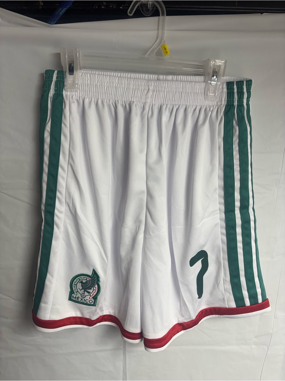 White Athletic Soccer Shorts with Green Stripes and Red Hem